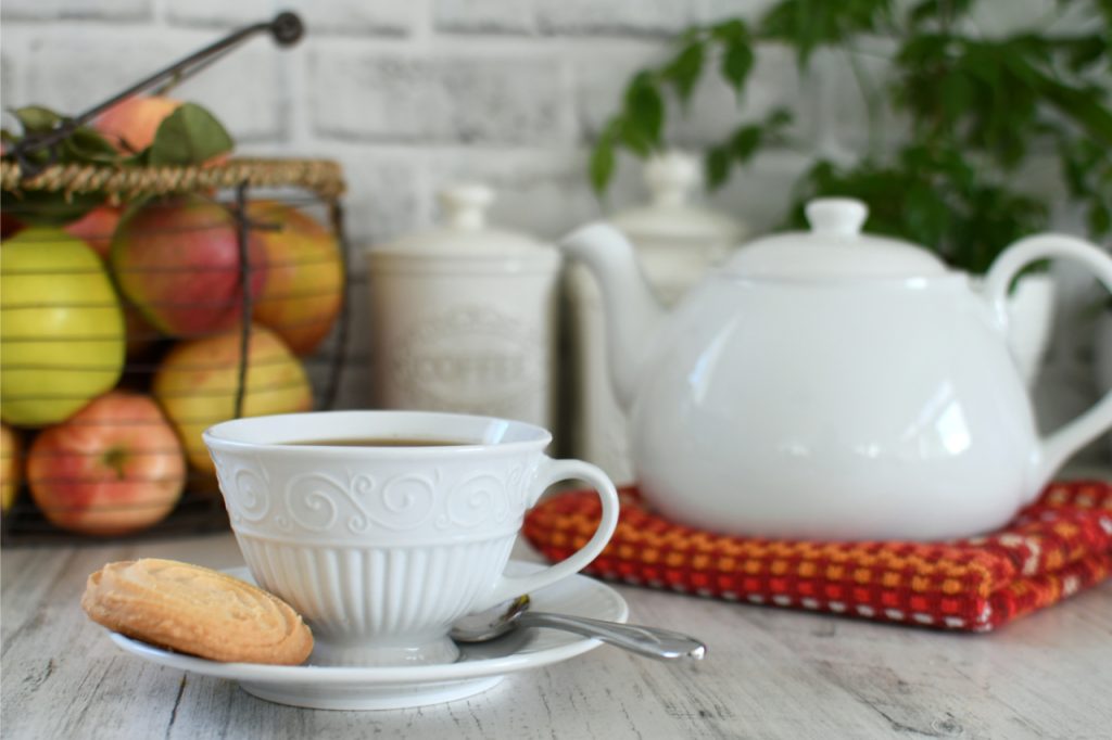 cup of hot white tea and a biscuit