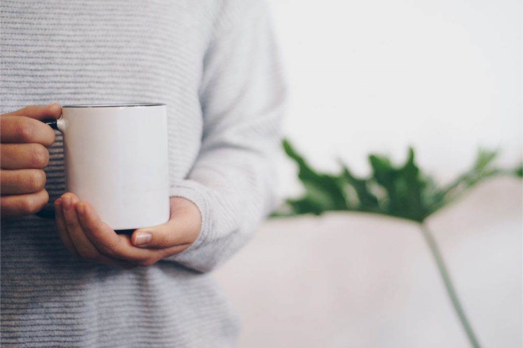 a man with a hot cup of chamomile tea