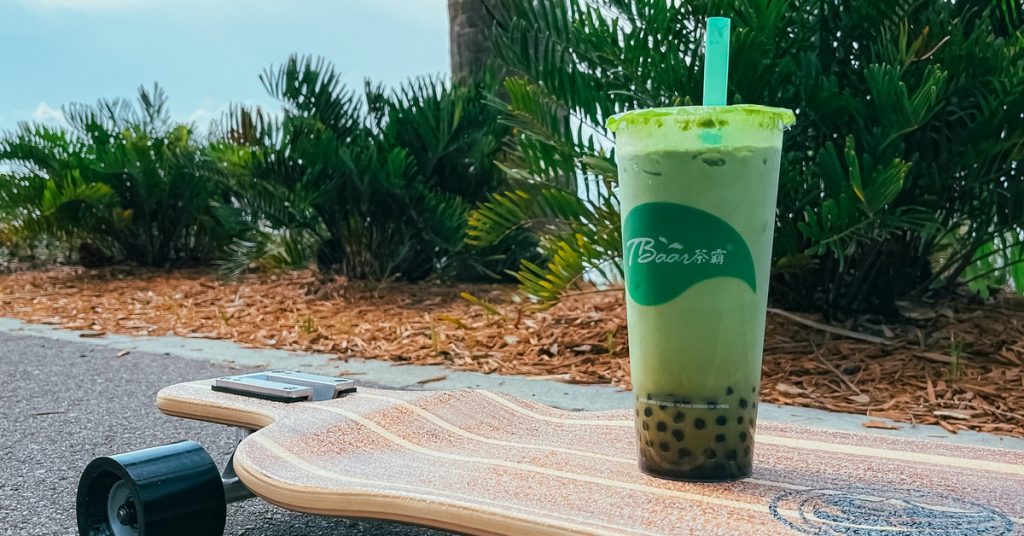 a cup of boba tea on a skateboard