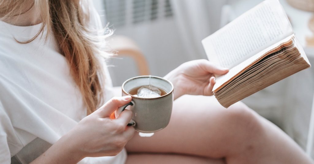 a girl holding a cup of tea