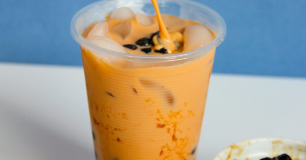 a beautiful orange bubble tea