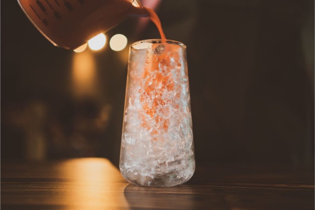 pouring thai milk tea over ice