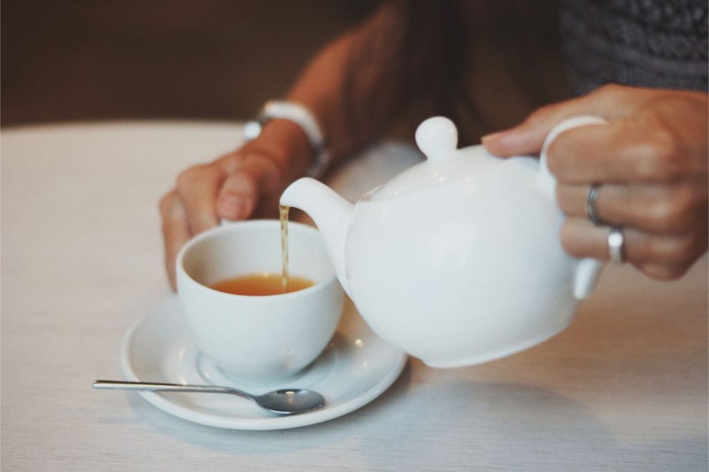 pouring a hot cup of tea