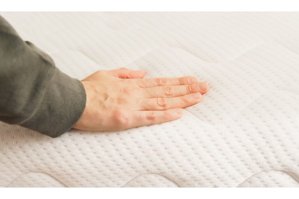 hand on green tea mattress