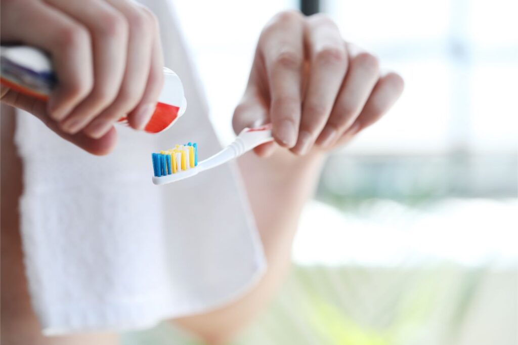 man brushing teeth after a cup of tea