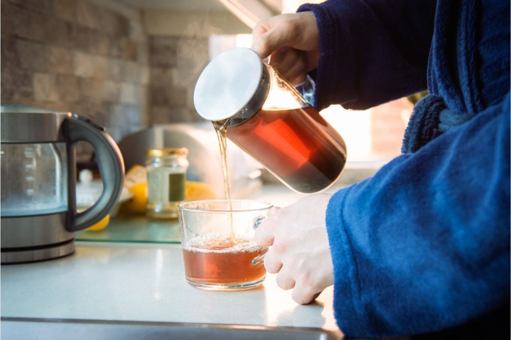 pouring a cup of decaffeinated black tea