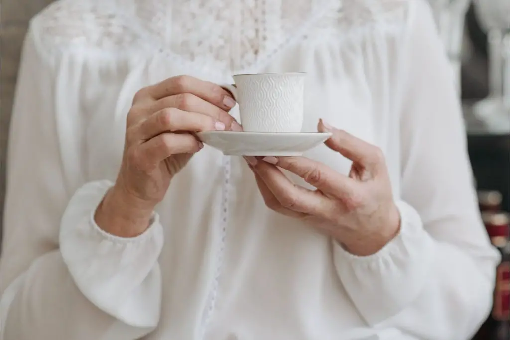 woman holding a hot cup of tea
