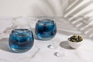 two glasses of iced butterfly pea tea