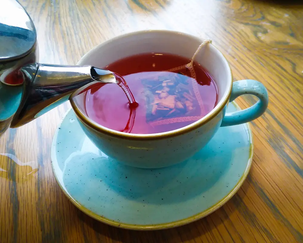 hot cup of english tea being poured